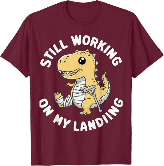 Still Working On My Landing Dinosaur Broken Bone T-Shirt - T-Shirt | Maroon