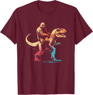 Bigfoot Riding A T-Rex - Funny Graphic Dino Sasquatch Lover T-Shirt - T-Shirt | Maroon