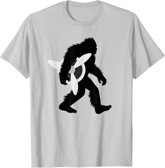 Bigfoot Carrying Airplane Propeller Sasquatch Pilot T-Shirt - T-Shirt | Ash